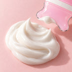 A swirl of white cream on a blush surface